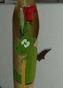 Manualitat amb cocodril verd i barret vermell muntat sobre vareta
